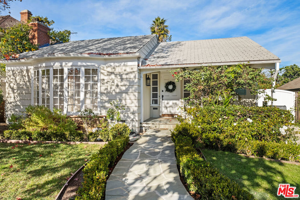 A beautiful jewel box of a home with delightful designer touches at every turn. Originally built in 1942, this 3 bedroom/3 bath single-story benefits from the timeless character and personality of an older home yet its newly remodeled infrastructure and updates ensure the ease of modern living. Wood floors, wainscotting, crown moldings, big Bay window and luxurious fireplace in the living room. This extraordinarily pretty home provides plenty of storage, spacious bedrooms and crystal-knobbed closets. Intricate lighting fixtures and an abundance of natural light create an airy, bright space. There's a cozy breakfast nook off the sun dappled kitchen, a den, dining room and the primary bedroom opens out to the lushly landscaped, private backyard complete with patio, lawn and area for additional storage. A truly stunning property on a quiet, family friendly street in Beverlywood in the enviable Castle Heights Elementary School District., this house is a real neighborhood treasure!