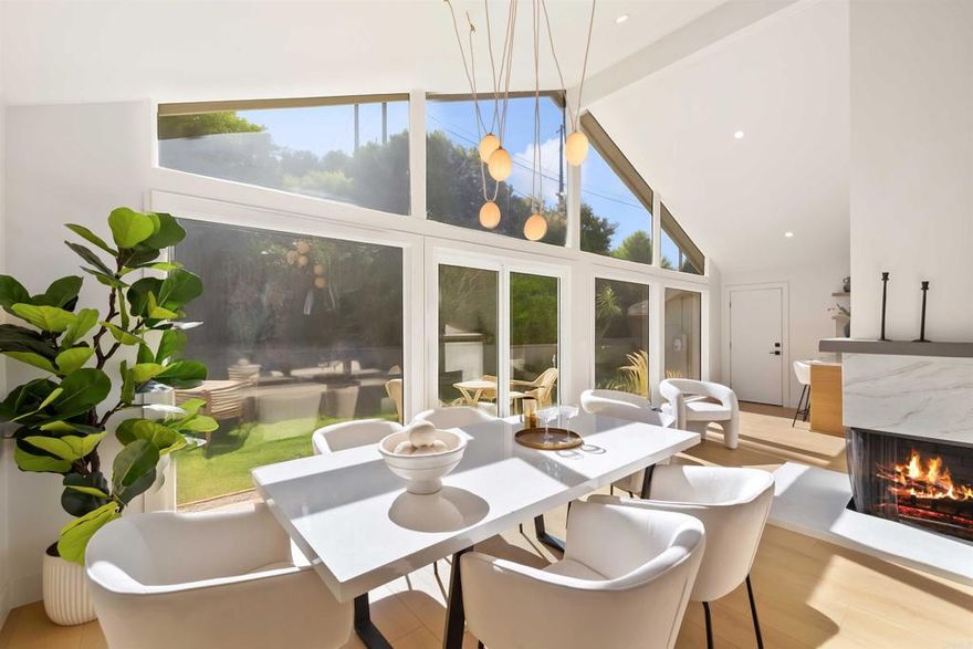 Tucked into the peaceful hills of the Hollywood Riviera, this captivating remodeled home blends luxurious finishes with effortless coastal living.   A bright entry opens to a sun-filled living room crowned by soaring ceilings and floor-to-ceiling windows framing the lush backyard beyond. Natural light pours across the wide-plank flooring, while the sleek fireplace anchors the space with warmth and sophistication. The adjacent dining area leads to a chef's kitchen designed to impress, featuring quartz countertops, shaker wood cabinetry, elegant fixtures, designer lighting, and gleaming appliances that elevate every meal.  The primary suite is a calming retreat with soft tones and abundant light, while secondary bedrooms offer flexible space for family, guests, or a stylish home office. Bathrooms showcase impeccable craftsmanship with fluted wood vanities, brushed gold fixtures, and stunning tilework that feels fresh and timeless.  Outdoors, the landscaped backyard invites relaxation and entertaining alike, enjoy a morning coffee on the sunlit deck or dinner under the stars surrounded by mature greenery.  Just around the corner from Rocketship Park and only minutes from pristine beaches, Riviera Village, vibrant coastal dining, and award-winning schools, this Hollywood Riviera gem offers the perfect blend of luxury and relaxed South Bay living.