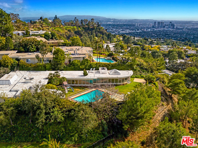 Top of Trousdale! Great fixer or redevelopment opportunity on huge flat, view lot. Explosive City/Ocean/Mountain views. No roof top obstructions. Photo's include renderings of architectural plans and designs by Richard Landry Design Group.