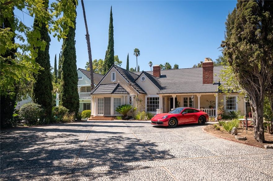 Welcome to an exceptional opportunity to own this remarkable Colonial-style residence in Glendale's prestigious Royal Boulevard neighborhood,  a celebrated enclave known for its timeless architecture and storied charm. Nestled on a private, gated lot, surrounded by mature trees, this beautifully preserved residence exudes character and vintage appeal with classic architectural details, proportions and period charm, perfectly suited to today's discerning homebuyers. Set on a generous 22,000 sqft. lot with park-like grounds and sparkling pool offering complete privacy and seclusion with thoughtfully designed living spaces. Sweeping drive leads to a dramatic grand entry, welcoming you in an elegant living room, rich in historic character highlighted by a stately fireplace, soaring ceilings and period details that echo the craftsmanship of a bygone era. Formal dining room sets the tone for impressive entertaining with its enduring beauty. A private library/office, enhanced by its own fireplace, provides and inspiring retreat for work and study. Featuring 4 bedrooms, including two primary suites conveniently located - one on each level. Second floor gracious master features luxurious bathroom and provides an access to a large view balcony. The beautifully renovated kitchen showcases a grand center island, custom cabinetry, and a sunlit breakfast nook. The expansive lot offers incredible scope for indoor/outdoor living, whether hosting by the sparkling pool or enjoying estates serene garden spaces. Entertain in style with a dedicated pool lounge with professional bar, creating the perfect setting for intimate evenings or grand celebrations. Property has two wings with a separate entries, giving an opportunity to enhance the classic period details, update for modern comfort, or expand to fit your lifestyle. Gated and secure, it is a true sanctuary just minutes from Glendale City conveniences. Grace and sophistication define this timeless Colonial estate that stands as a testament to Glendale rich architectural heritage.