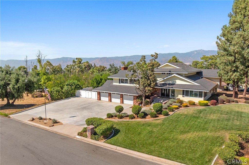 In the Highly Desirable Hills of South Redlands, along scenic Sunset Dr. your new home awaits! Walking distance to Mariposa Elementary and a short golf cart ride to Redlands Country Club, this home offers a comfortable, functional layout that facilitates full enjoyment of your home! {Be sure to read the *photo captions* as you scroll through the photos}. Step through the grand double door entrance to your entry foyer (or step in from your 3 car garage) and head to one of your TWO Living Rooms. Prepare a meal in your gourmet kitchen with wrap around counters, a counter bar and a casual dining space that opens to your lower Living Room; Or enjoy the meal in your formal Dining Room or your fully covered Outdoor Dining patio. Head up the back staircase to find 2 mid-level bedrooms w/ great closets and a full bathroom. Turn the corner to a short staircase leading to your Primary Suite (one of 2 entrances). Look at that view from your room!! The suite also offers 2 separate vanity dressing rooms, each with their own closet and their own door into the shower room. The Upper Living Room (w/ fireplace and beautifully scenic balcony) has direct access stairs down from the Primary Suite and up from the entry foyer. The lower level private bedroom and bathroom (at the back of the house) create the perfect guest room, in-law suite or home office / work studio. The backyard is the perfect place to relax, play & entertain! So much space, a large pool, covered spaces with shade, a playground, a lush greenbelt, a gas-plumbed firepit, and a fresh concrete slab w/ electricity ready to build your workshop, shed or studio. Easy access to bathroom & shower from the pool through your indoor laundry room. Need space for cars and recreational toys? The 3-car garage and huge (drive through style) driveway has room for it all! Desirable schools, beautiful views, parks and a Country Club are just some of what makes this neighborhood so desirable! Tranquil nature surrounds you and yet easy access to the freeway is quick. "Redlands – known in 1900 as 'The City of Millionaires' and later as 'The City of Beautiful Homes' welcomes you! Founded in 1881... Redlands is a quintessential 'big town' with a 'small town' feel". The Historic Downtown, Historic Train Station, Kimberly Crest House & Gardens, The Redlands Bowl Summer Music Festival and a wealth of great parks and trails!! Come see this truly remarkable home!!