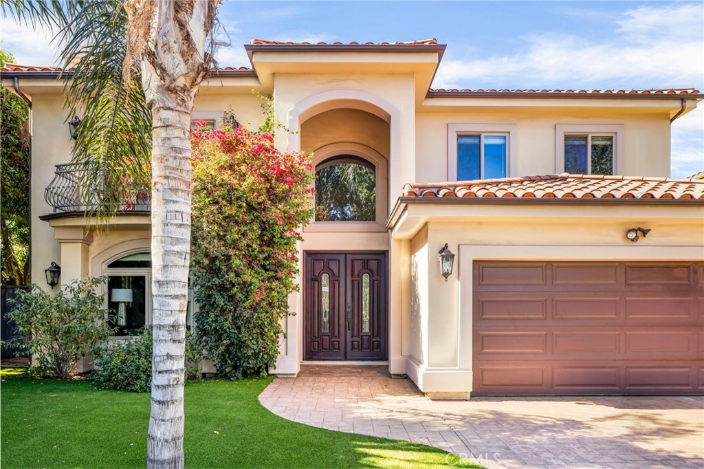 Stunning Mediterranean retreat in the heart of Encino’s most coveted tree-lined enclave. Set on an expansive 10,000+ sq ft lot, this 5-bedroom, 4-bathroom estate offers over 4,300 sq ft of refined living space, blending timeless architectural details with modern luxury.
A dramatic double-height foyer with wrought iron accents and travertine floors sets the tone for the open, light-filled floor plan. Elegant formal living and dining rooms provide seamless flow for entertaining, while the spacious family room with fireplace opens through sliding glass doors to a lush, ultra-private backyard oasis. Outside, enjoy a sparkling pool, generous patio, and manicured grassy areas—perfect for both grand gatherings and intimate relaxation. The gourmet chef’s kitchen is a true centerpiece, featuring an oversized center island, stainless steel appliances, abundant cabinetry, and a sunlit breakfast nook. A versatile guest suite or home office with full bath completes the main level.
Upstairs, four bedrooms include the luxurious primary retreat with two oversized walk-in closets and a spa-inspired bath boasting dual vanities, soaking tub, and separate shower. Additional highlights include a dedicated laundry room, custom finishes throughout, and an attached two-car garage. Located just moments from Ventura Boulevard’s premier dining, shopping, and cafes—with effortless access to the 101 and 405 freeways—this turn-key estate delivers the perfect blend of elegance, privacy, and convenience.