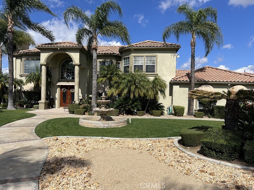 Start living your dream in this paradise that embraces comfort, luxury, tranquility, and elegance. Ideally planned on a quiet Cul-De-Sac with breathtaking views of summer sunsets, and mountain views. Property entrance with a custom automated iron gate with secure digital and remote access. Extra-long driveway for multiple RVs and a Grand RV garage large enough for a 42-footer RV. Landscaped with meticulous care and drought resistant plants in the front, and grass in the back for children to play. Mature trees and fruit trees throughout. Elegant entrance with exquisite double solid wood doors and ceramic tile floor throughout first floor. Spiral elegant wood stairway casing professionally crafted in the front and a 2nd stairway access in the back for casual access or service access. Inviting formal living room with cathedral ceilings and luxury chandelier lighting. Mediterranean style formal dining room, Classic grey granite counter tops over oak kitchen cabinets. Kitchen equipped with double stainless-steel ovens, microwave oven, dishwasher, food warmer, stainless steel stove, and a separate ice maker. Plantation shutters throughout the whole house and some rooms with custom window decorations. Chandeliers and ceiling fans. Burbon carpet and professionally installed ceramic tile. 6-inch baseboards and crown molding throughout the home. Purchased 47 solar panel system that generates enough electricity to power the entire estate at an estimated savings of 85%. Intercom system, dual ac units with their own thermostats, central vacuum system, and alarm system. 3 of the 5 bedrooms have their own private bathrooms. The inviting outdoor living comes with an extra-large custom pool with remote controls that can be operated from inside the house, beach entrance, Spa, decorated with a waterfall and a kiddie pool. The patio, barbecue, and fire pit were designed to entertain large groups for summer and cold nights. The extra-large RV garage was designed with great architecture for large motorhomes with large amperage for sustainable recharges. And do not forget the horse stalls for the modern cowboys that love comfort and country living combine in the same paradise. Large office room with separate access that can be used for work or play. Enjoy the NO HOA and no Special assessment restrictions. All of this and more in the prestigious area of Wood Crest.
