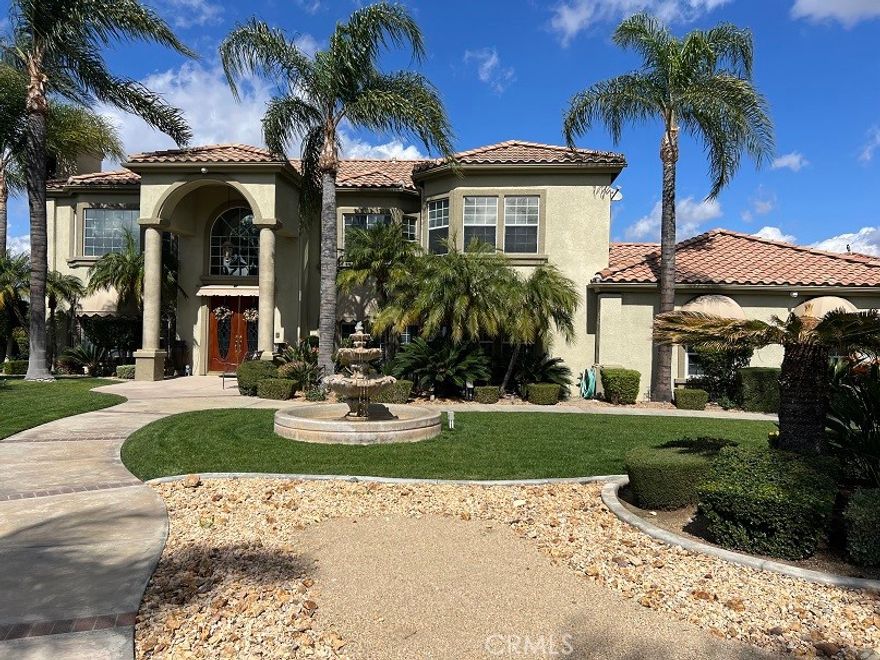 Start living your dream in this paradise that embraces comfort, luxury, tranquility, and elegance. Ideally planned on a quiet Cul-De-Sac with breathtaking views of summer sunsets, and mountain views. Property entrance with a custom automated iron gate with secure digital and remote access. Extra-long driveway for multiple RVs and a Grand RV garage large enough for a 42-footer RV. Landscaped with meticulous care and drought resistant plants in the front, and grass in the back for children to play. Mature trees and fruit trees throughout. Elegant entrance with exquisite double solid wood doors and ceramic tile floor throughout first floor. Spiral elegant wood stairway casing professionally crafted in the front and a 2nd stairway access in the back for casual access or service access. Inviting formal living room with cathedral ceilings and luxury chandelier lighting. Mediterranean style formal dining room, Classic grey granite counter tops over oak kitchen cabinets. Kitchen equipped with double stainless-steel ovens, microwave oven, dishwasher, food warmer, stainless steel stove, and a separate ice maker. Plantation shutters throughout the whole house and some rooms with custom window decorations. Chandeliers and ceiling fans. Burbon carpet and professionally installed ceramic tile. 6-inch baseboards and crown molding throughout the home. Purchased 47 solar panel system that generates enough electricity to power the entire estate at an estimated savings of 85%. Intercom system, dual ac units with their own thermostats, central vacuum system, and alarm system. 3 of the 5 bedrooms have their own private bathrooms. The inviting outdoor living comes with an extra-large custom pool with remote controls that can be operated from inside the house, beach entrance, Spa, decorated with a waterfall and a kiddie pool. The patio, barbecue, and fire pit were designed to entertain large groups for summer and cold nights. The extra-large RV garage was designed with great architecture for large motorhomes with large amperage for sustainable recharges. And do not forget the horse stalls for the modern cowboys that love comfort and country living combine in the same paradise. Large office room with separate access that can be used for work or play. Enjoy the NO HOA and no Special assessment restrictions. All of this and more in the prestigious area of Wood Crest.