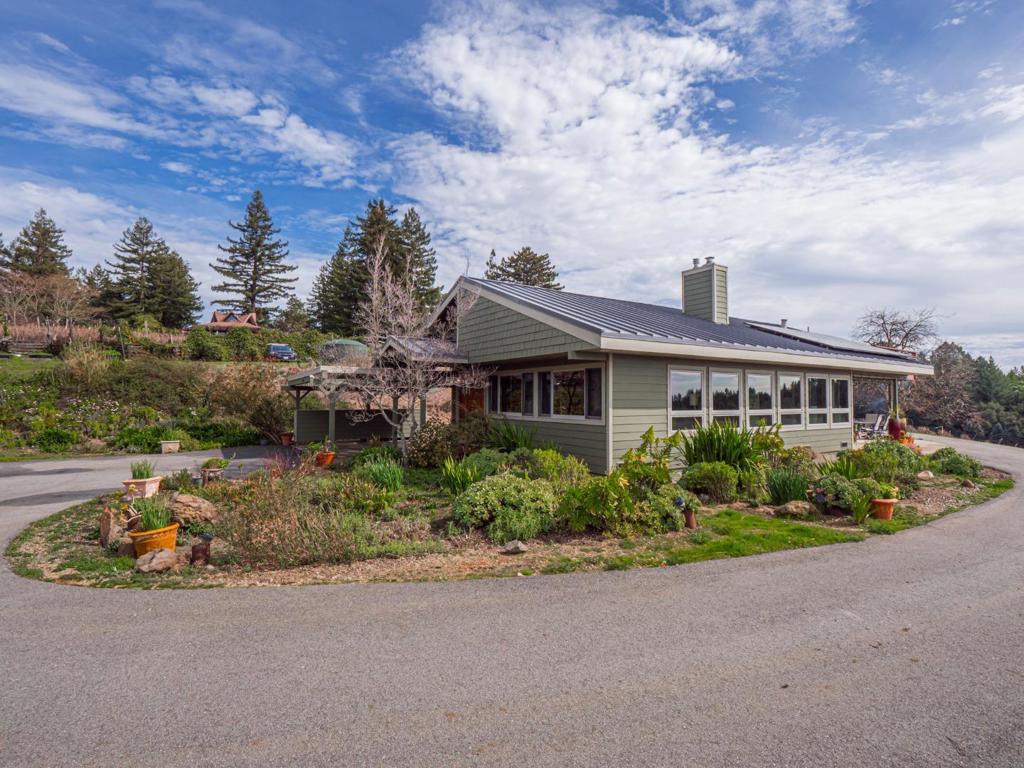 This incredible Corralitos home & property is a true masterpiece! Nestled on a 4.35 acre ridge top parcel, the custom home boasts amazing ocean, vineyard & mountain views and exudes quality features & amenities throughout. Features list for the main home include: walls of windows to take in the amazing views, hand scraped custom wood floors, open beam ceilings, terrific kitchen w/custom cabinets, granite counters, stainless appliances and double ovens; fire resistant Hardie plank siding and metal roof, owned solar electricity system; viewing deck; generous attic, work shop, heat pump w/ multiple splits heating system, 2 patios for entertaining & attached carport. Detached ADU w/kitchen, full bath, sleeping loft, solar heat pump combined w/split heating system, attached 2 car garage utilized as a studio (gives you a total of 3 bedrooms and 2.5 baths)- truly flows like an additional 500 sq ft of living- , metal roof and Harde plank siding. Rolling/sloped parcel, deer fenced, groomed w/mature fruit trees, planting beds, 1/3 share of well generating 27 gallons per minute plus a free-flowing spring provides an abundance of water w/four 5k holding tanks, hard wired generator & much more! You will be over the moon, come take a walk in the clouds, you are going to love Corralitos living!