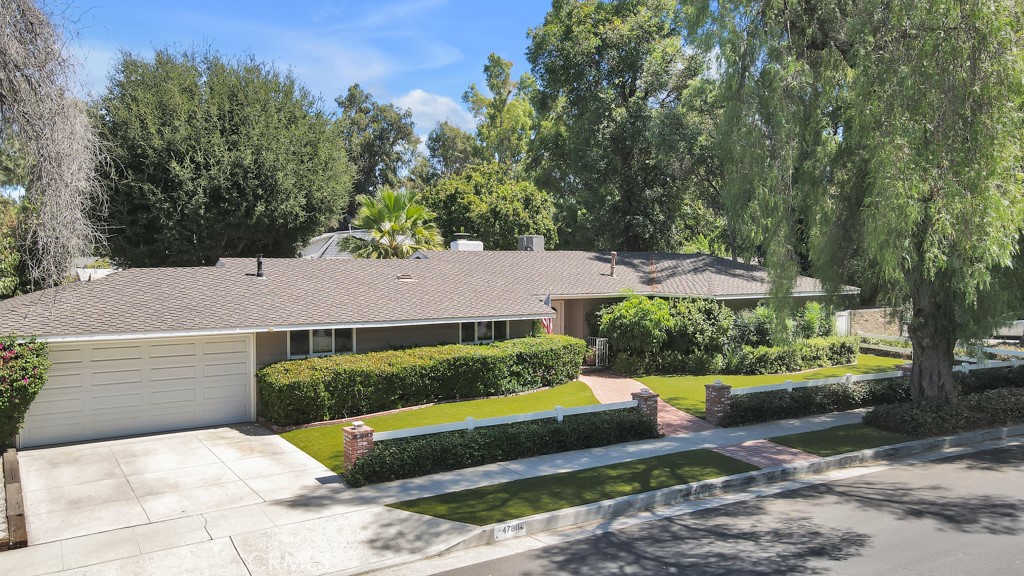 Completely Remodeled Home on a Double Corner Lot South of Ventura Blvd.
This stunning, fully renovated home offers modern upgrades and spacious living in a prime location south of Ventura Blvd. Set on a large, 13,070 sq ft double corner lot, this property blends style with comfort and functionality.
The heart of the home is the beautifully redone kitchen, featuring high-end built-in appliances including a Sub Zero fridge and freezer, a Wolfe oven and cooktop, custom stainless steel range hood, and counter seating – perfect for casual dining and entertaining. The adjacent living room is inviting with its charming brick fireplace, creating a cozy atmosphere.
The primary bedroom includes a walk-in closet and a private, en-suite bath. Three additional well-sized bedrooms offer built-in cabinetry, providing ample storage space.
This home has been thoughtfully upgraded with meticulous attention to detail, including new flooring, energy-efficient windows and sliders, custom interior doors, updated roof and gutters, modern plumbing, renovated bathrooms, crown molding, recessed lighting, and custom wood shutters.
The garage has been tastefully converted into a versatile 400 sqft room that has served as a game room and a bedroom. It features built-in closets and adds additional flexible space to the home.
Step outside to the expansive rear yard, beautifully landscaped with lush greenery and a generous lawn area, offering a perfect setting for relaxation and outdoor activities. The standout feature is the remodeled heated pool with remote control, as well as new decking and plumbing, creating a resort-like atmosphere. A large covered patio is perfect for outdoor dining and entertaining.
Additional features include a 18’ x 6’ Tuff shed, an upgraded electrical panel, and an 18KW backup generator wired to the house for peace of mind during power outages. Additional parking space is available next to the driveway for convenience.
The garage conversion and approximately 6' x 11' dining area extension were done without permits and are not included in the listed 1,736 Sq Ft.
This home offers a unique blend of comfort, style, and functional upgrades all on a double lot.