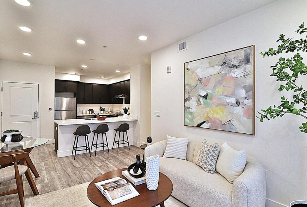 Experience the perfect blend of style, comfort, and convenience in this single-level condo - the only floor plan of its kind in the building. Designed for effortless living, this ADA-accessible home features an expansive open kitchen with a large island and plenty of cabinets, solid stone countertops, espresso designer cabinets, and abundant storage, all complemented by stainless steel appliances and includes gas stove, washer & dryer. Light and airy interiors are enhanced by double-pane windows, central heat & AC, and a north-east facing balcony offering serene mountain views. Enjoy your own dedicated private patio and the ease of elevator access in a secure, gated community. Located in the sought-after Irvington District with top-rated Irvington High School, this home is truly move-in ready. HOA covers building & in-unit insurance, utilities, and exterior maintenance, with a healthy 84% reserve fund for peace of mind. This condo is also ideal as an investment/rental property.