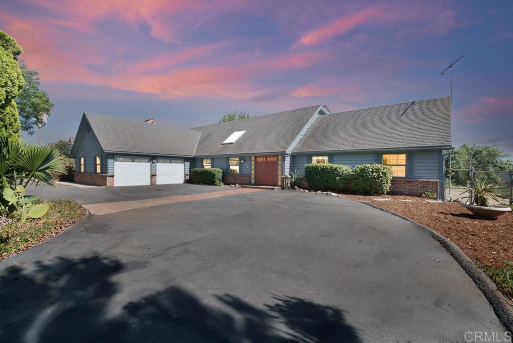 Welcome to 1139 Big Oak Ranch, a magnificently captivating home with majestic views, Owned Solar, and Mature Fruit Trees! Idyllically nestled on a quiet street just minutes from town, this 4BR/3BA, 3,400+SQFT residence offers an inviting aesthetic with lovely landscaping, beautiful brick pavers, and grand double entry doors. Explore the immaculate interior to discover an openly flowing layout, soft natural light, crown molding, large living/formal dining area, eat-in kitchen w/walk-in pantry, and a family room with wood ceilings, built-in wet bar, and woodburning fireplace. Perfectly appointed on the upper-level, the oversized primary bedroom impresses with a romantic fireplace, dual walk-in closet, scenic viewing deck, and an en suite. Rich with delicious fruit trees (avocados, cuties, grapefruit, peach, pears, etc.), the outdoor space also boasts a huge paved patio and sprawling greenspace, situated on just shy of an acre.