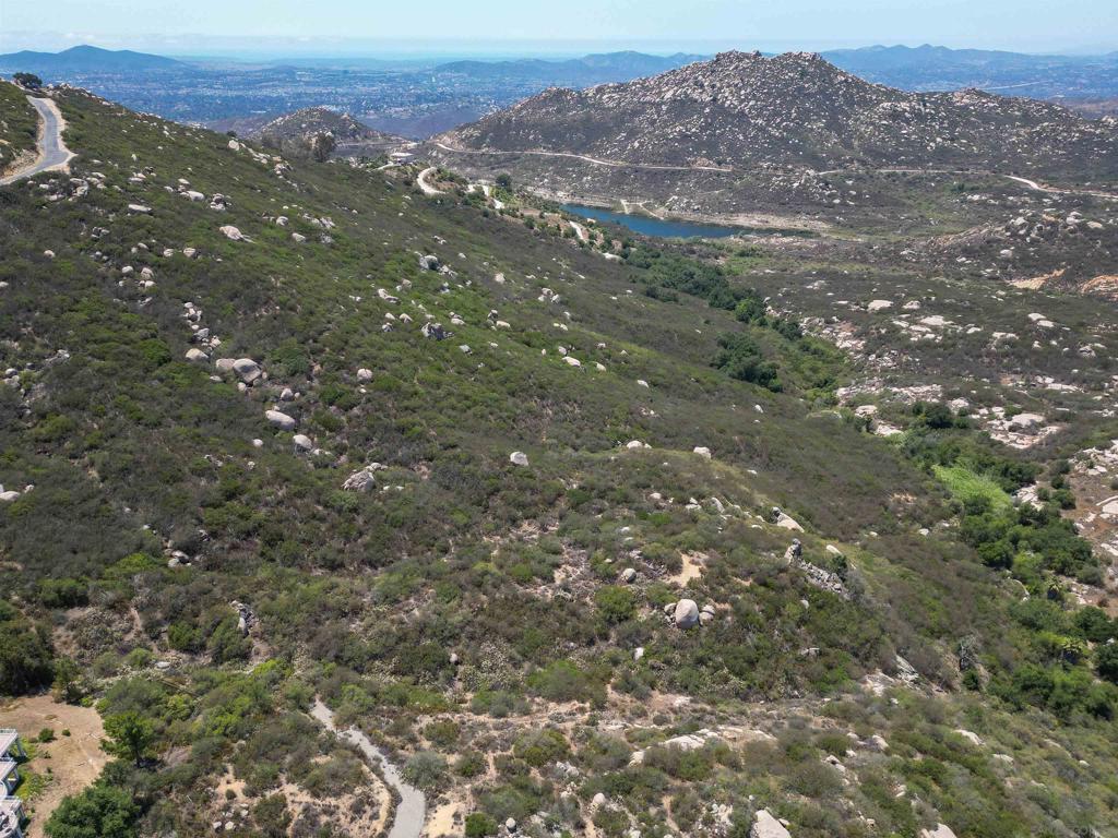 Stunning View Lot on Ramona’s Desirable West Side! Welcome to your dream homesite with sweeping panoramic views, breathtaking sunrises and sunsets, and a direct line of sight to iconic Mt. Woodson. Nestled near beautiful Lake Ramona, this peaceful property backs to open space owned by the water district for added privacy. A water meter is already installed, and the perc test is on file with the Parcel Map. Access is via a full easement road—dirt at the start, then paved right to the property. Zoned A70 with an “L” animal designator, it's ideal for horses and hobby farming. Gently sloped terrain could be perfect for avocados, grapevines, or your own hillside garden. Don’t miss the site plan in the photos/documents—this is the peaceful country lifestyle you’ve been waiting for!