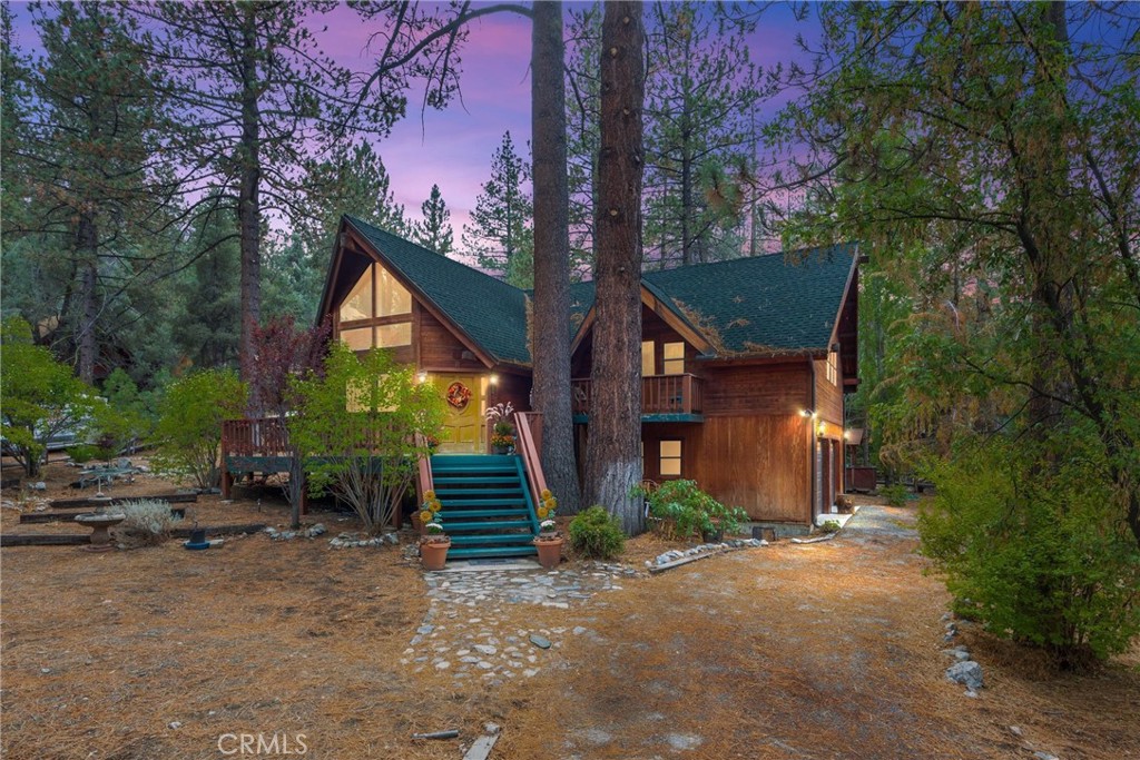 Welcome to your Mountain Oasis in Pine Mountain Club, California! Nestled in the beauty of the Los Padres National Forest, this warm and inviting home blends timeless craftsmanship with modern comfort. Step inside to soaring wood-beamed cathedral ceilings, golden hardwood floors, and an abundance of natural light. At the heart of the home, the grand central living room features a cozy wood-burning stove set on a brick hearth, where your eyes are drawn upward to the stunning tongue-and-groove knotty pine ceiling and charming loft above.
The spacious layout includes two dining areas, a bright open kitchen, a wet bar with built-in beverage fridge and cabinetry, and a utility room with laundry. The large en-suite primary retreat offers two closets—including a generous walk-in with a safe—and a private balcony. A secondary bedroom (without a closet) also enjoys its own balcony, while the loft provides a cozy hideaway with two oversized storage closets.
Additional highlights include a full-sized two-car garage with direct home access, built-in workbench, utility sink, and a refrigerator. Outdoor living shines with a wrap-around front porch and a large 12K+ lot, the perfect place to soak in the serenity of the mountains.
Tucked on a quiet cul-de-sac across from Lampkin Park and close to the Village, you’ll enjoy easy access to dining, shopping, and community events. As a member of the Pine Mountain Club HOA, you’ll also have access to incredible amenities—golf course, equestrian center, pool, tennis and pickleball courts, recreation room with library, hiking and biking trails, and more. Lampkin Park itself offers a softball field, courts for basketball, beach volleyball, and bocce ball, plus barbecue and picnic areas. The Mountains are Calling....
Title reflects 2+2. Buyer to investigate & verify all property details to their own satisfaction. Some rooms are Virtually Staged.