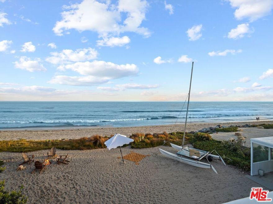 Seamless indoor-outdoor oceanfront living on spectacular Broad Beach means leisure, entertaining, and views, views, views. With approximately 73 feet of beach frontage, this private, gated beach home features mid-century styling, high plank-and-beam ceilings, floor-to-ceiling windows, abundant options for outdoor entertaining, plus a sensational upstairs primary suite. From the lovely, landscaped entry the home opens to a grand living/dining/kitchen space. Just beyond is a large partially covered patio for lounging and al fresco dining, the pristine expanse of Broad Beach, and the ever-changing panorama of ocean, islands, coastline, and sky. Lavish natural light illuminates the ocean-view kitchen, with butcher-block countertops, new appliances, and a breakfast bar. The exceedingly comfortable living room has a fireplace and the dining area is suitable for casual gatherings and sophisticated soires. Five of the home's six bedrooms are on the entry level. They include an ocean-view suite, an en-suite bedroom with a separate entrance currently being used as a gym/office, an additional beachfront bedroom, and an attached guest suite with a separate entrance. The primary suite presides over the entire second floor where it commands breathtaking whitewater views through enormous windows. It also features a large sun deck, a fireplace with a sitting area, and dual bathrooms. In addition to this classic Malibu beach home, the oceanfront property of approx. 0.65 acre has plans in process with the City of Malibu for a new approx. 4,170 square foot home with much of the underlying work completed, plus there are also plans and renderings for a Richard Landry-designed home of approx. 10,000 square feet.