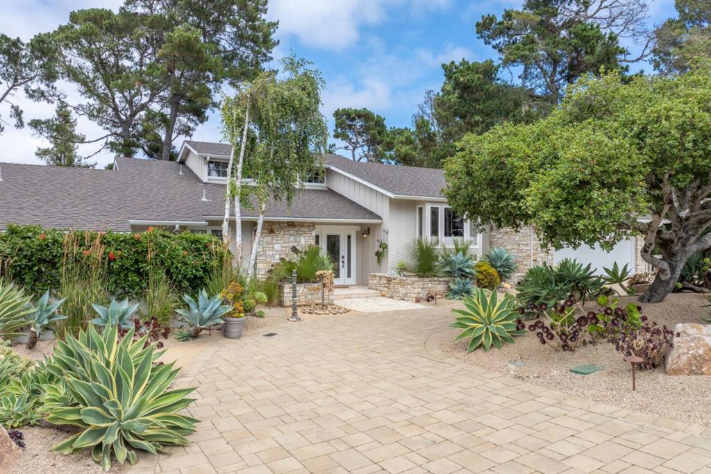 Tucked in Monterey's coveted Deer Flats Park sunbelt, this inviting home offers a rare blend of elegance, tranquility, and connection to nature. Morning light filters through soaring windows in the dramatic living room, where rich wood accents and a striking fireplace frame forest views. The serene primary suite, with its cozy window seat, fireplace, dual closets, and private spa patio, is a perfect place to unwind and relax. Two additional bedrooms and a full bath provide privacy and comfort for family or guests, while the gourmet kitchen flows easily to the adjacent den and office nook. A versatile artist loft with sink offers an inspiring space to create and dream. Thoughtful decks invite gatherings under the trees, and a spacious two-car garage adds convenience to this peaceful, nature-inspired retreat.