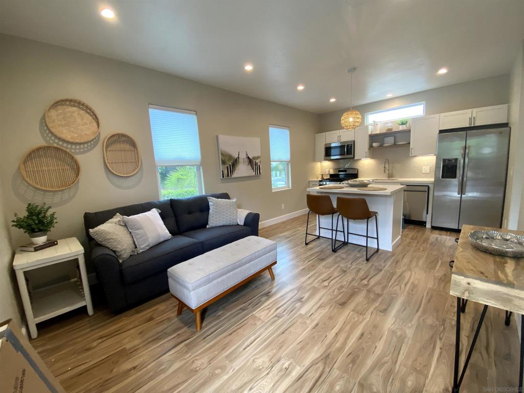 Escape to your own, private sanctuary in Carlsbad! This immaculate, furnished 1-bedroom home with a private, gated patio with seating and outdoor grill offers the perfect blend of modern luxury and serene coastal living. Forget crowded complexes; this is your exclusive haven, boasting a private entrance and ample street parking for your convenience. Step inside a light-filled great room, featuring a full-sized kitchen equipped with elegant GE Profile stainless steel appliances and crisp white quartz countertops, including a convenient island for dining. The inviting living area is designed for relaxation, with a streaming-ready smart TV, a comfortable sofa bed, and a stylish adamant. Indulge in the spa-like modern bathroom, featuring a huge walk-in shower with floor-to-ceiling tile, a sophisticated 42" vanity, and an LED-lit mirror. The spacious Master Bedroom is a peaceful retreat, furnished with a queen-sized bedroom set, a plush hybrid mattress, a stacked GE washer/dryer closet, a closet with an organizer, and mirrored closet doors for added style and functionality. Enjoy independent living with your own HVAC split air unit, a separate tankless water heater, and dedicated Wi-Fi access. Your private patio includes a gas grill and outdoor dining. For added convenience and security, the home features USB outlets and keyless entry. Beyond your private oasis, you'll discover a vibrant Carlsbad lifestyle right at your fingertips. Walk to the Dove Library, catch a movie at Cinepolis Cinemas, grab groceries at Vons Market, or savor delicious meals at local favorites.