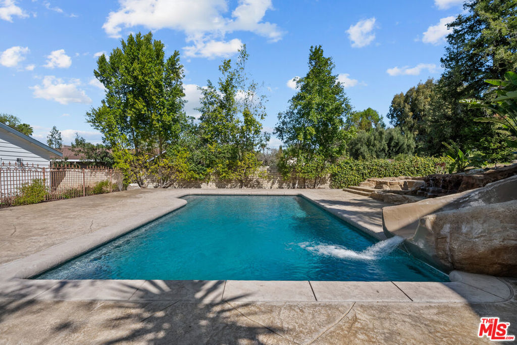 Where Everyday Living Feels Like a Resort Getaway! This stunning single-story residence offers 4 bedrooms and 3.5 bathrooms, blending timeless elegance with modern comfort. From the moment you arrive, the grand half-circle motor court sets the tone with its stately presence and abundant guest parking. Inside, a welcoming foyer opens into parlor, where a charming fireplace and soaring vaulted ceilings create an atmosphere of warmth and sophistication. The chef's kitchen is a true masterpiece, featuring granite countertops, a brick oven, stainless steel appliances, abundant cabinetry, and high-end finishes throughout. French doors open directly to the backyard, enhancing the indoor-outdoor lifestyle perfect for entertaining in the California sunshine. The private primary retreat is a haven of relaxation, featuring an expansive walk-in closet and SPA-like ensuite with soaking tub, walk-in shower, dual vanities, and designer finishes. French doors provide direct access to the backyard escape. Two additional bedrooms each feature ensuite baths, ensuring comfort and privacy for family and guests. A versatile fourth bedroom is ideal for a home office, gym, or guest quarters. A full laundry room and AMPLE storage complete the thoughtful design of the front home. Step outside into your resort-style backyard, where a Grotto-style POOL with waterslide, built-in BBQ, lush landscaping, and multiple lounge areas set the stage for unforgettable gatherings. A spacious attached two-car garage provides both convenience and privacy. Rare Opportunity: In addition to the main residence, a beautifully UPGRADED rear home is also available for lease. This private retreat spans approximately 2,200 SQ FT and offers 2 bedrooms (one oversized), 2 FULL bathrooms, an open loft, a full kitchen, generous living and dining areas, stacked laundry, and extensive built-in storage. The primary suite includes a walk-in closet and a stylish ensuite bath. A separate GATED driveway with RV parking provides exceptional privacy and flexibility. Please contact the listing agent directly for photos and additional details on this unique lease opportunity. Don't miss the chance to experience the pinnacle of Southern California living! Schedule your private tour today!