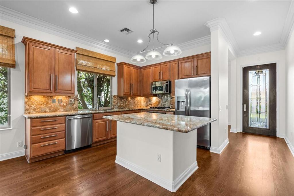 Popular Serrente model features open great room living space with a large ensuite primary bedroom, second bedroom, shared bath and a cozy den/office off the entryway. Special features include premium granite upgrade with full backsplash, elaborate crown molding and ceiling fans in every room. Includes washer, dryer, water system, wired for security, newer HVAC, and stainless-steel appliances. Enjoy the two-hole putting green in the back yard featuring an extended back patio and built-in barbeque for hours of comfortable outdoor living. In the heart of a vibrant Del Webb community, this home has been refreshed and ready for its new residents. Buyers to choose new bedroom flooring.