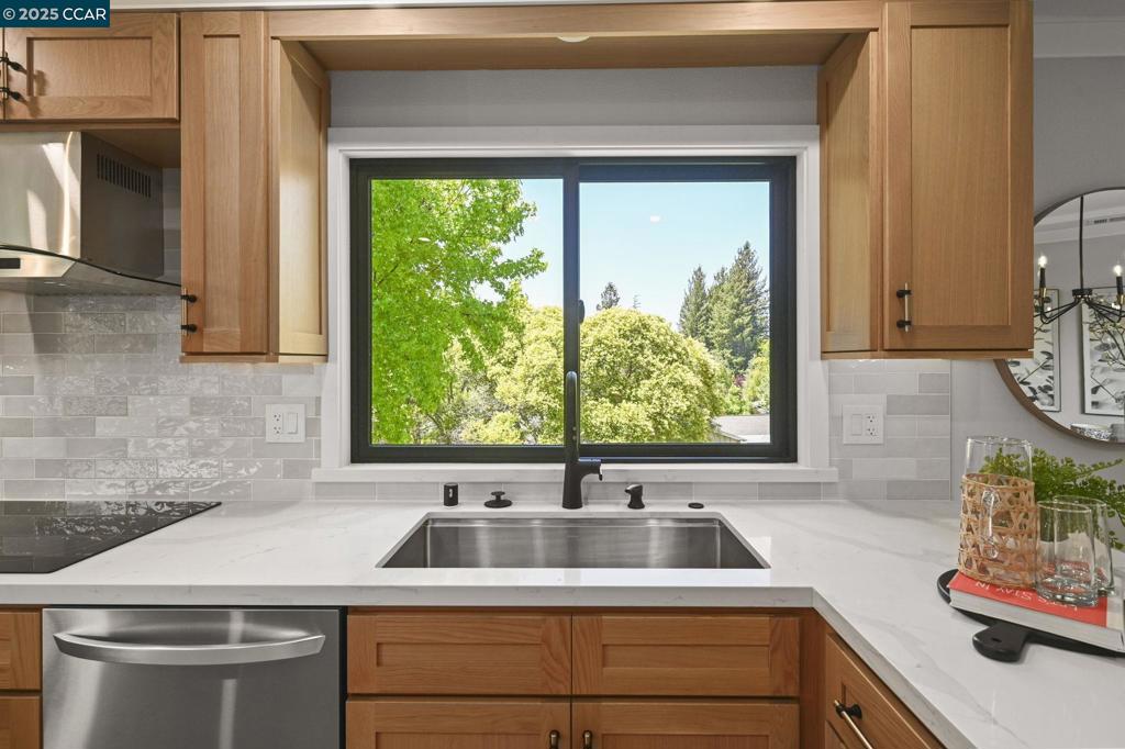 This exquisitely remodeled home by Gallo & Associates blends timeless craftsmanship with modern sophistication. At its heart is a custom open-concept kitchen with natural white oak shaker cabinets, gleaming quartz countertops, and premium LG appliances—including a second wall oven with steam and sous vide. A dry bar with dual-zone wine fridge elevates the dining area. The vaulted-ceiling living room offers ambient lighting, a custom electric fireplace with oak mantle, shiplap detail, and built-in cabinetry with integrated media hookups. The serene primary suite features a marble spa bath with dual showerheads, double vanity, walk-in and secondary closets, plus a cozy sitting area with fireplace and TV connections. Enjoy coffee in the sunlit breakfast nook, framed by corner windows with views of the golf course and mature trees. Additional highlights: private office/den, spacious laundry with LG front-loaders, utility room with built-ins, and garage with loft storage. Anderson windows, recessed lighting, central HVAC with heat pump, and attic fans ensure year-round comfort. Exterior perks include access lighting and a deeded golf cart space. Just a short walk to Creekside dining, the Pro Shop, and Event Center—graceful living awaits.