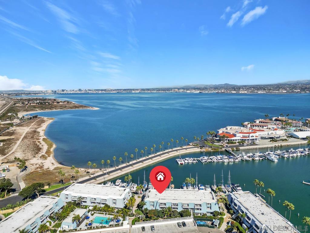 Experience waterfront luxury living in this stunning Coronado Cays condo. With scenic San Diego Bay and Pacific Ocean views, this recent and fully renovated property offers the perfect blend of style and comfort. Architecturally designed by a premier Coronado architect, not one detail was overlooked. The 2-bedrooms are appointed with true ensuites. The fully permitted (City and HOA approved) redesign includes an additional den/office, which is conveniently located next to the 3rd full bathroom on the main floor, and can easily live as a 3rd bedroom! The custom touches continue and are complimented by a new kitchen with stainless steel appliances, shaker-style cabinets, and quartz countertops. Entertain guests in the spacious dining area for eight. The shiplap ceiling adds an open/beach feel, while upgraded tile accents enhance the bathrooms, kitchen, stairs, and fireplace surround. The primary bedroom is highlighted by its stunning ensuite with walk-in glass rain shower and custom closet system. Enjoy breathtaking ocean and bay views from the primary suite’s balcony as well! Recently installedAC, updated windows, sliding doors, and luxury vinyl plank flooring complete the modern aesthetic along with a new washer, gas dryer, water heater, central heating unit and electric fireplace. Montego Village features a private pool/spa and clubhouse for residents to relax and enjoy. Live the coastal dream in this premier and exceptional Coronado Cays condo steps to the bay and a short walk to the sand, with boat slips available in the complex, and the nearby Cays Yacht Club!