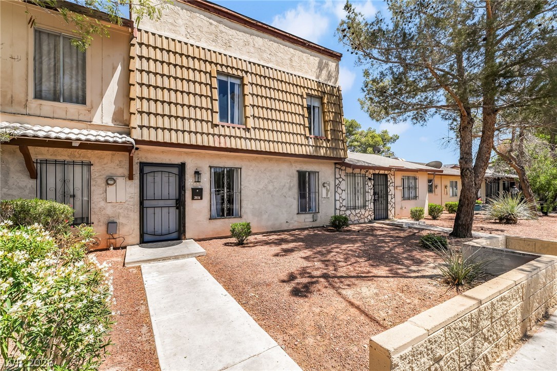 Charming townhouse-style exterior with textured st