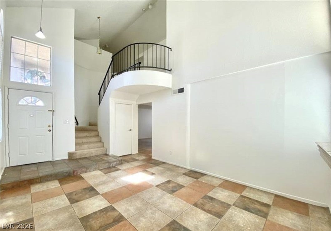 Entrance foyer featuring a high ceiling and light