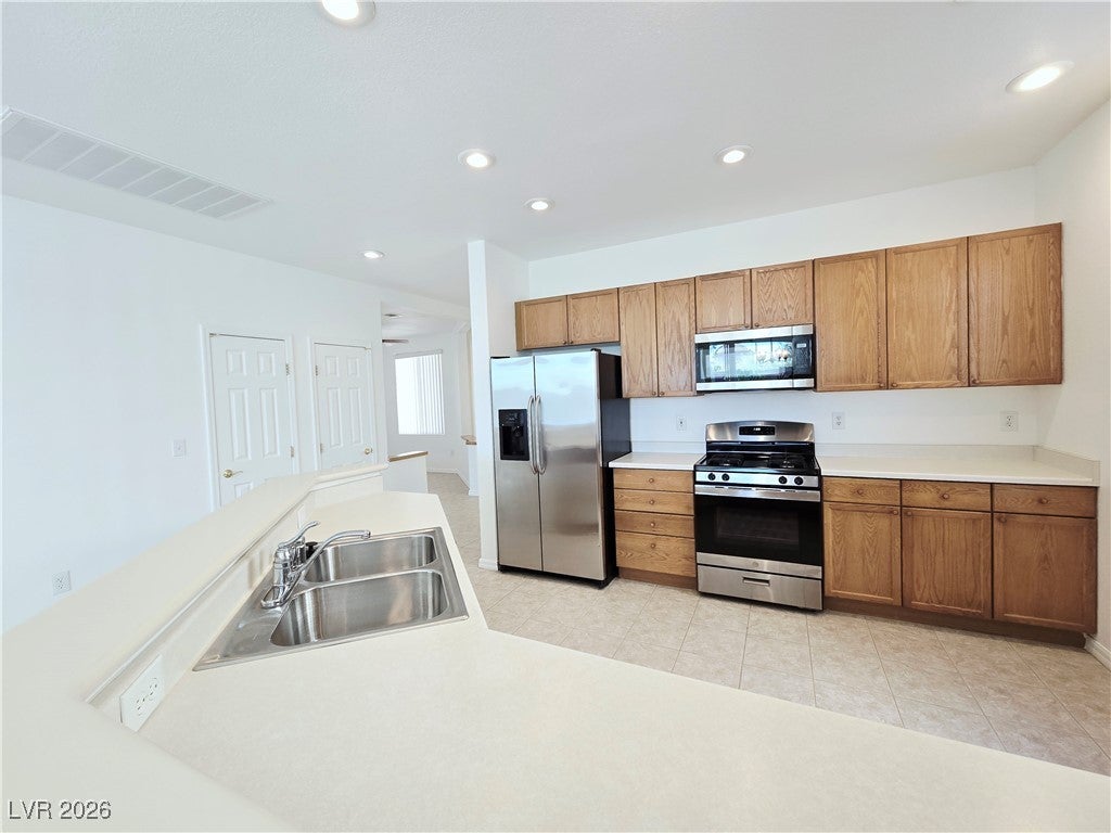 Kitchen featuring stainless steel appliances, brow