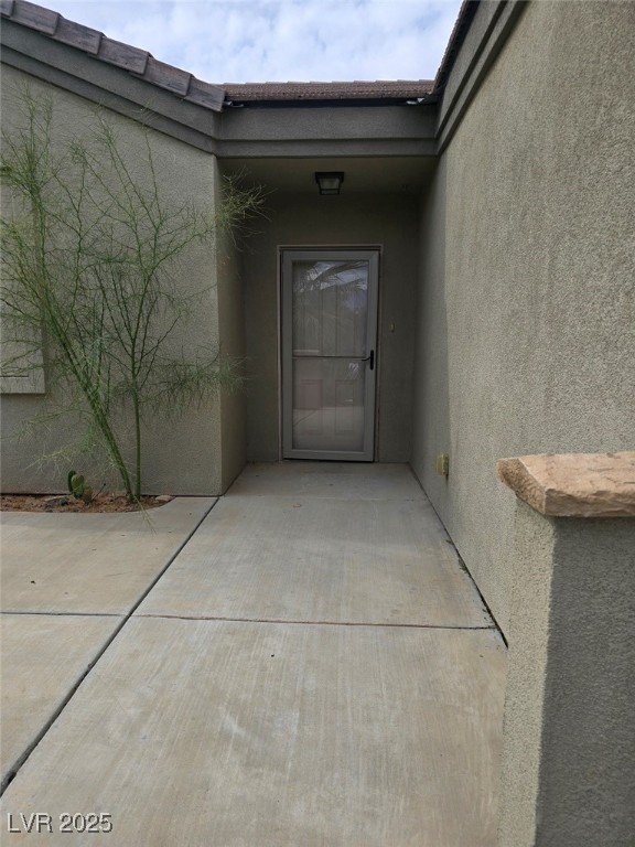 Property entrance with stucco siding