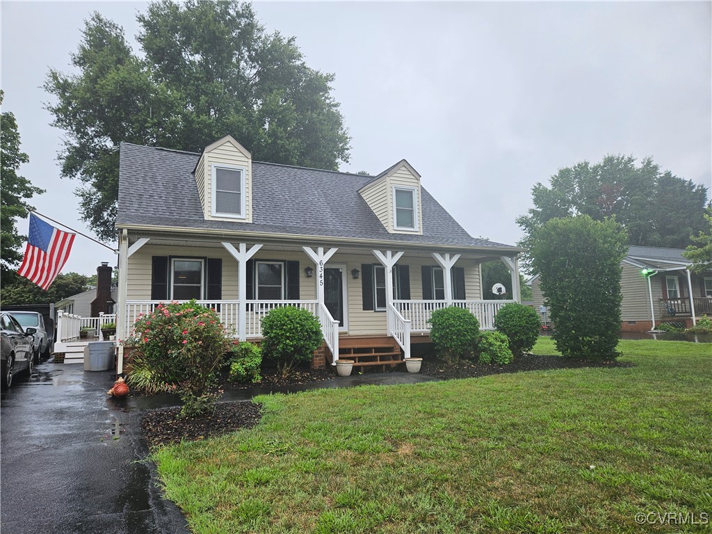 Cape cod-style house featuring covered porch and a