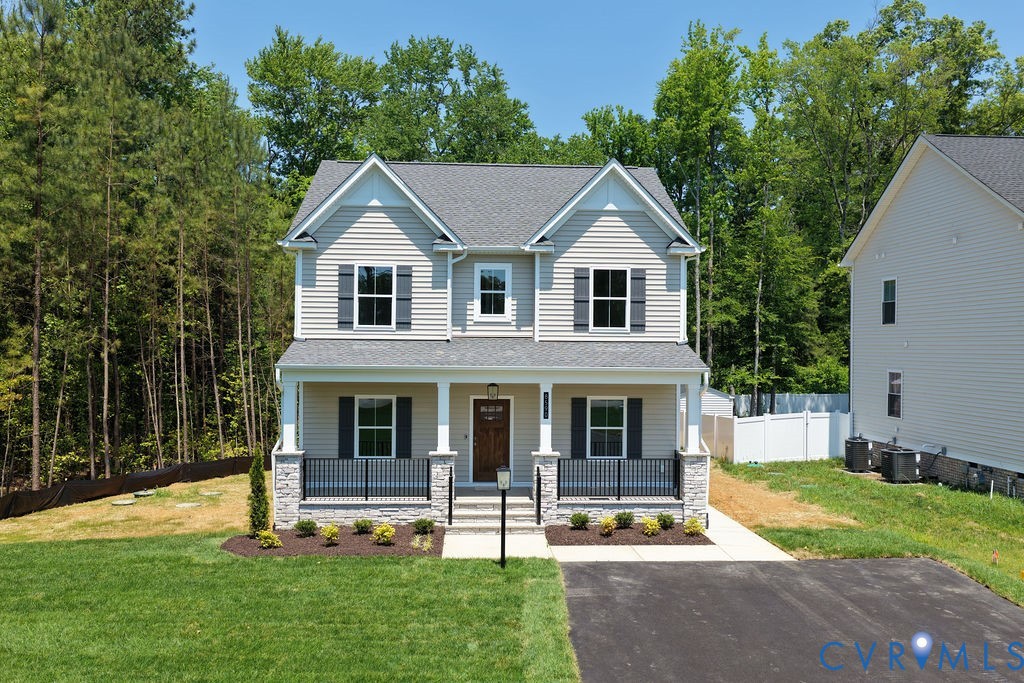 Two-story residence featuring light-toned siding a