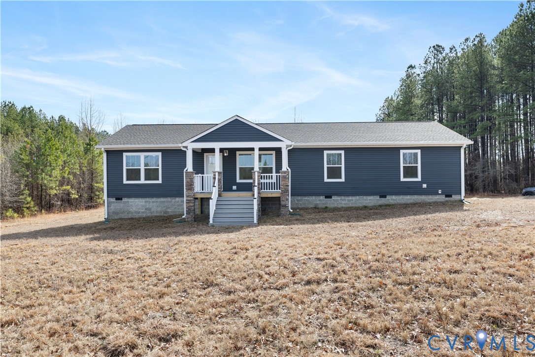 Ranch-style residence featuring a dark blue siding