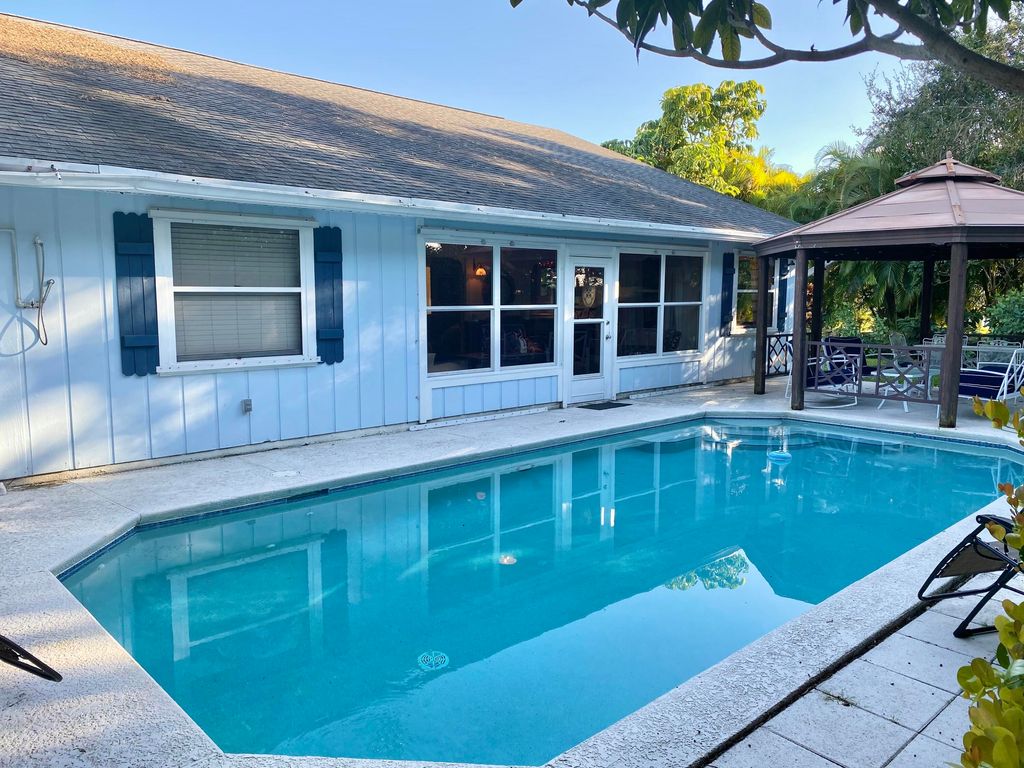 Photo of 1904 NE Avenida Dracaena, Jensen Beach, FL 34957 (MLS # RX-10848423)