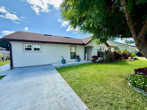 Photo of 2409 SW Hinchman Street, Port Saint Lucie, FL 34984 (MLS # RX-11119972)