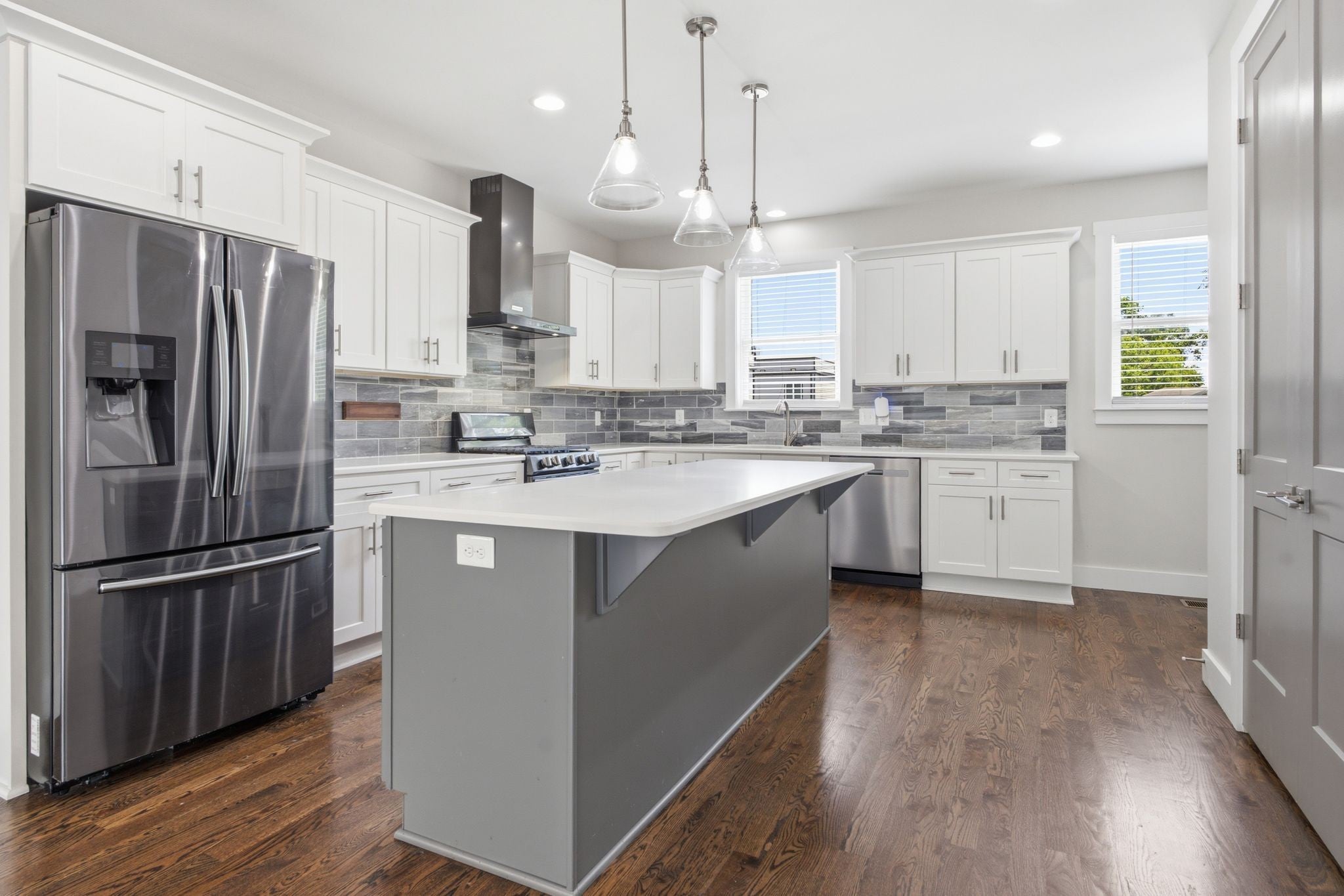 3-bed condo for sale in Old Hickory, TN 37138, 2205 Dabbs Ave Kitchen with a gray center island with a white counter, white cabinets and pendant lights over the island