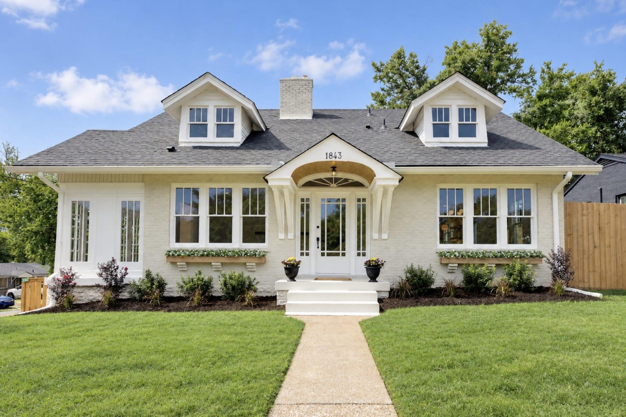 3-bed home sold in Nashville, TN 37208, 1843 25th Ave N Single family cottage at 1843 25th Ave N, Nashville, TN 37208, with white brick walls, a gray shingle roof and two dormer windows