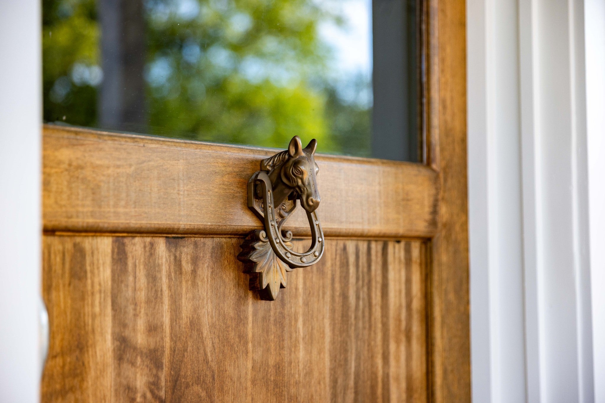 4-bed home for sale in College Grove, TN 37046, 6615 Eudailey Covington Rd Close view of a bronze horse head door knocker on a wood door with a glass upper panel