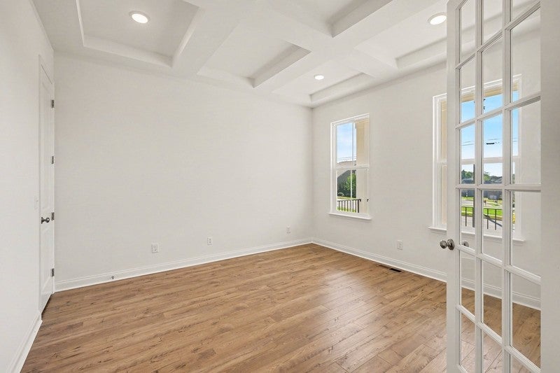4-bed home for sale in Nashville, TN 37221, 205 North Jenna Ct Room with a coffered ceiling, recessed lighting, wood-look flooring and windows overlooking the lot