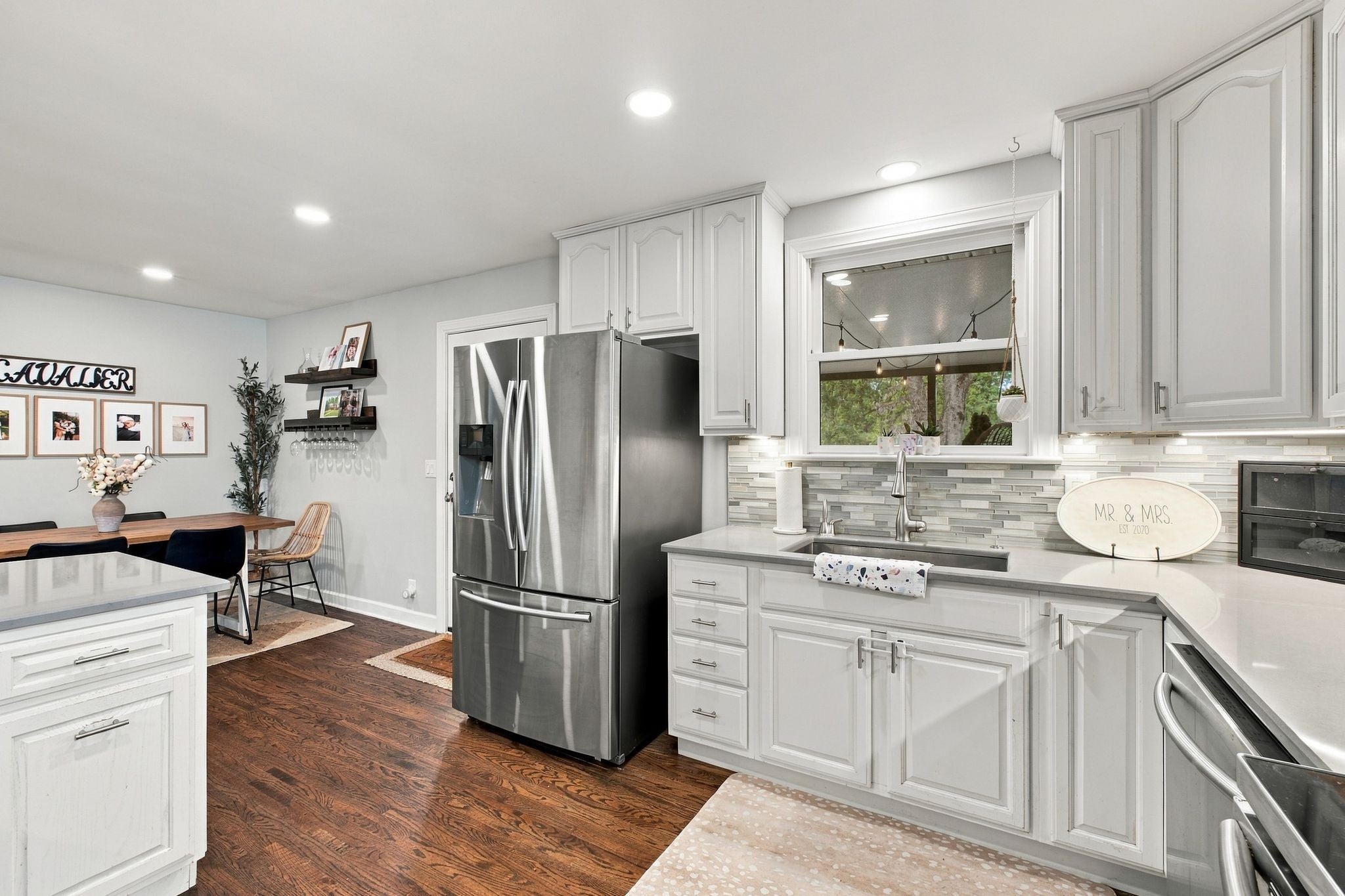 3-bed home for sale in Nashville, TN 37211, 613 Tobylynn Dr Kitchen with white cabinets, stainless steel refrigerator, stone countertops and a tiled backsplash beside a window over the sink