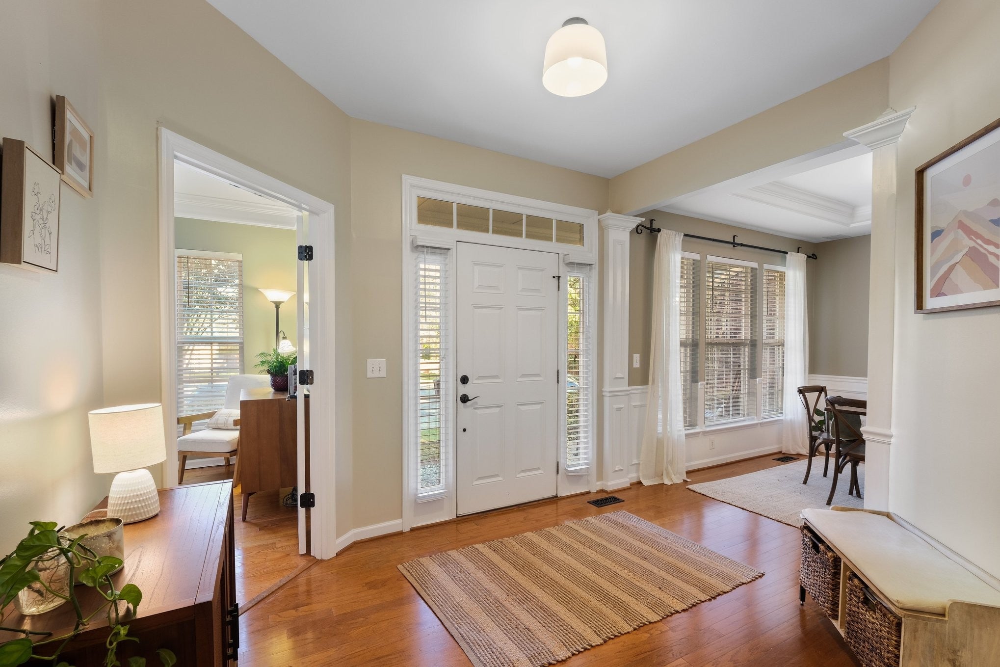 5-bed home for sale in Franklin, TN 37064, 403 William Wallace Dr Entry foyer with wood floors, a white front door with sidelights and transom, and an arched opening into the dining room