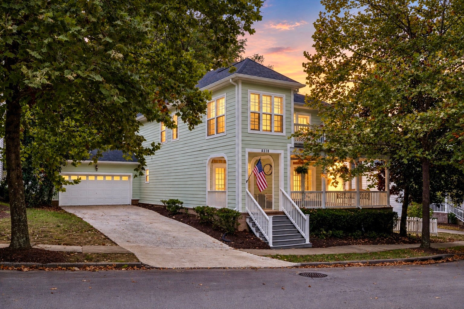3-bed home for sale in Nashville, TN 37211, 8348 Saint Danasus Dr Two-story home at 8348 Saint Danasus Dr, Nashville, TN 37211, with pale green lap siding, a two-car garage and a front porch lit at dusk