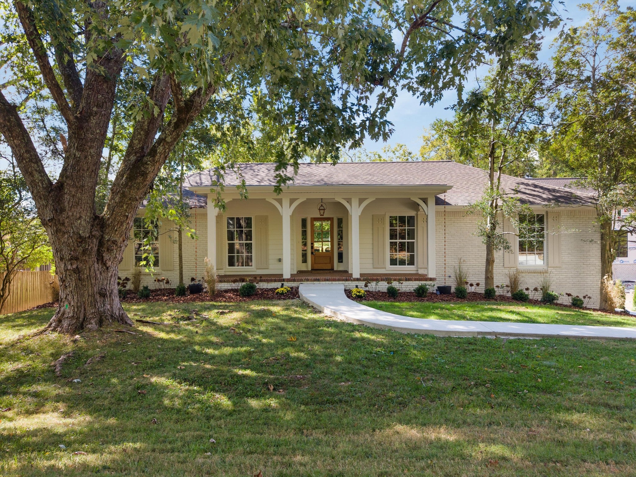 4-bed home sold in Nashville, TN 37221, 205 Hicks Rd Single-family home at 205 Hicks Rd, Nashville, TN 37221, with white brick exterior, a covered front porch with white columns and a curved walkway under a large tree