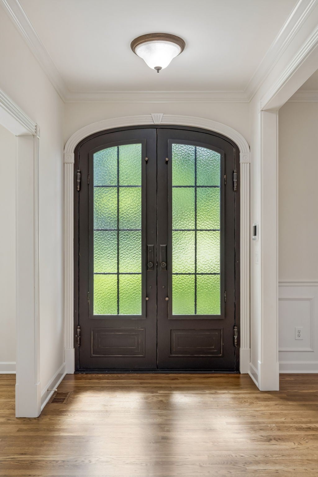 4-bed home for sale in Brentwood, TN 37027, 1521 Puryear Pl Entryway with a dark arched double door, wood floors, crown molding and a flush ceiling light