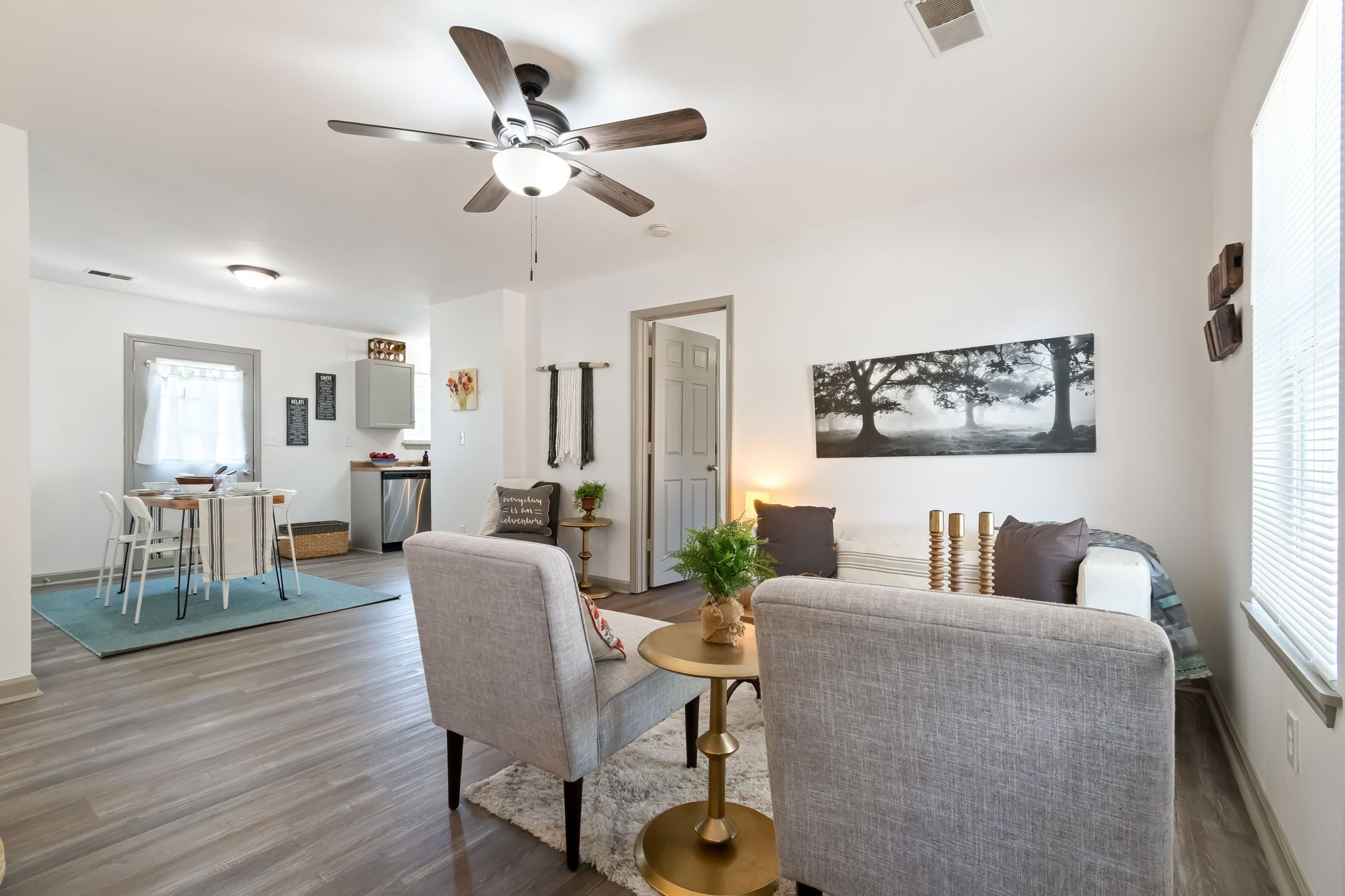 3-bed home for sale in Nashville, TN 37207, 2674 Old Matthews Rd Open living and dining area with wood-look vinyl plank floors, a ceiling fan and a galley kitchen beyond the dining table