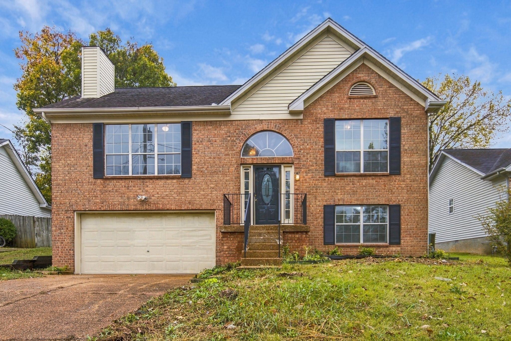 3-bed home for sale in Antioch, TN 37013, 1109 Burlingame Ct Brick front elevation with an arched entry window, dark shutters and a front stair with black iron railing