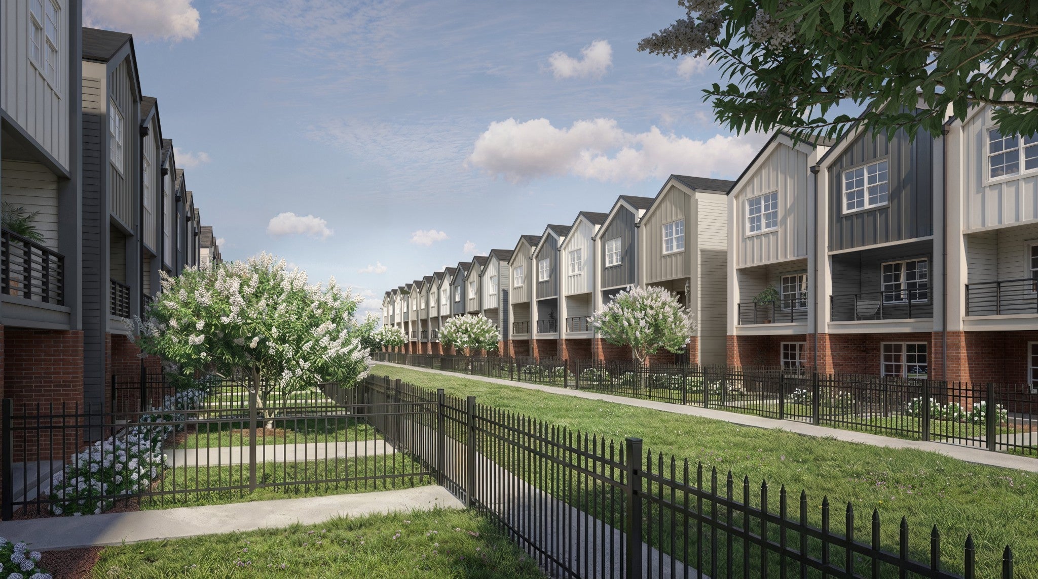 2-bed condo for sale in Nashville, TN 37216, 219 Straton Ln Row of three-story townhomes with balconies and brick bases along a fenced path lined with trees and grass