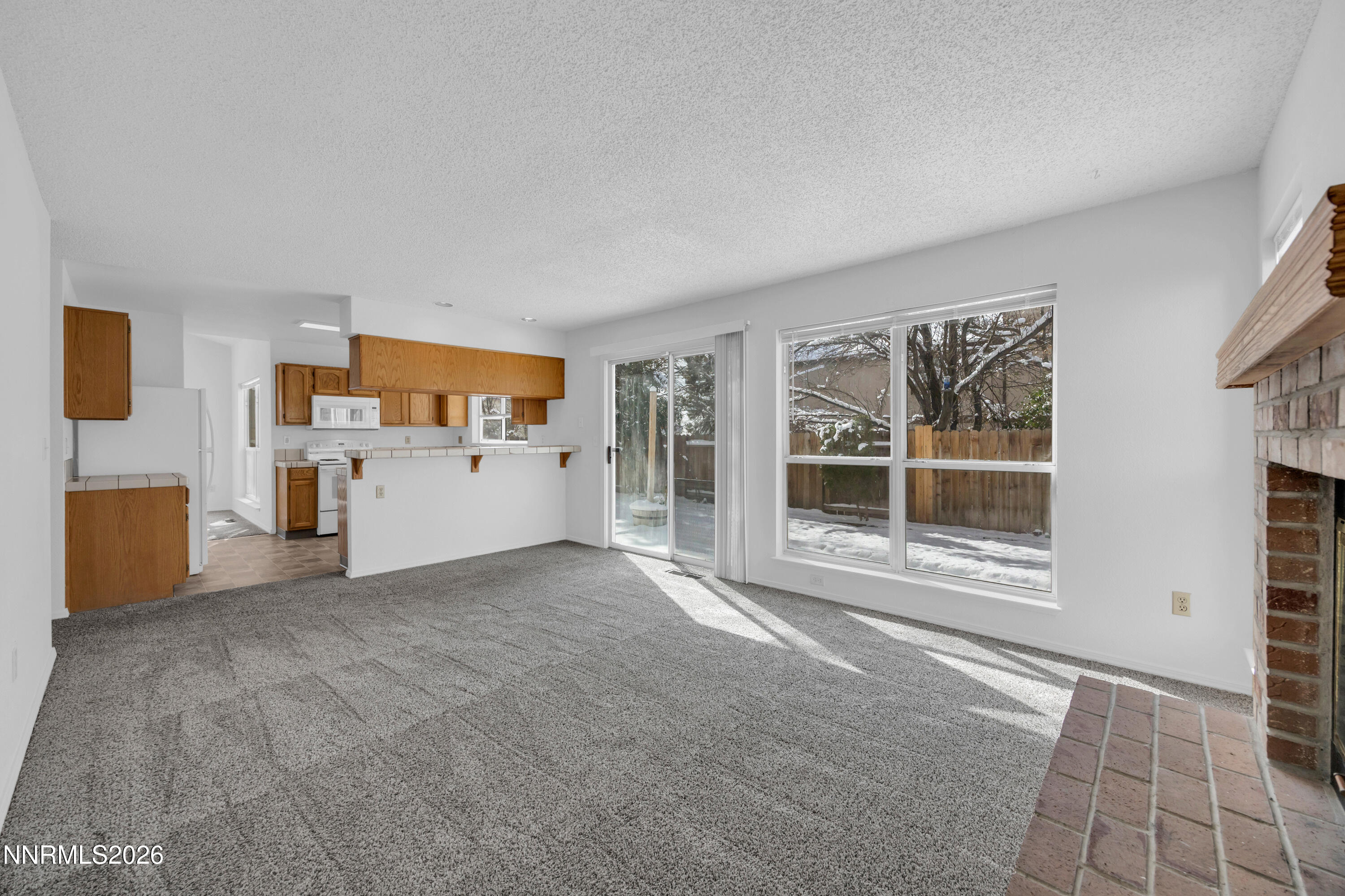 Windcrest family room looking to kitchen