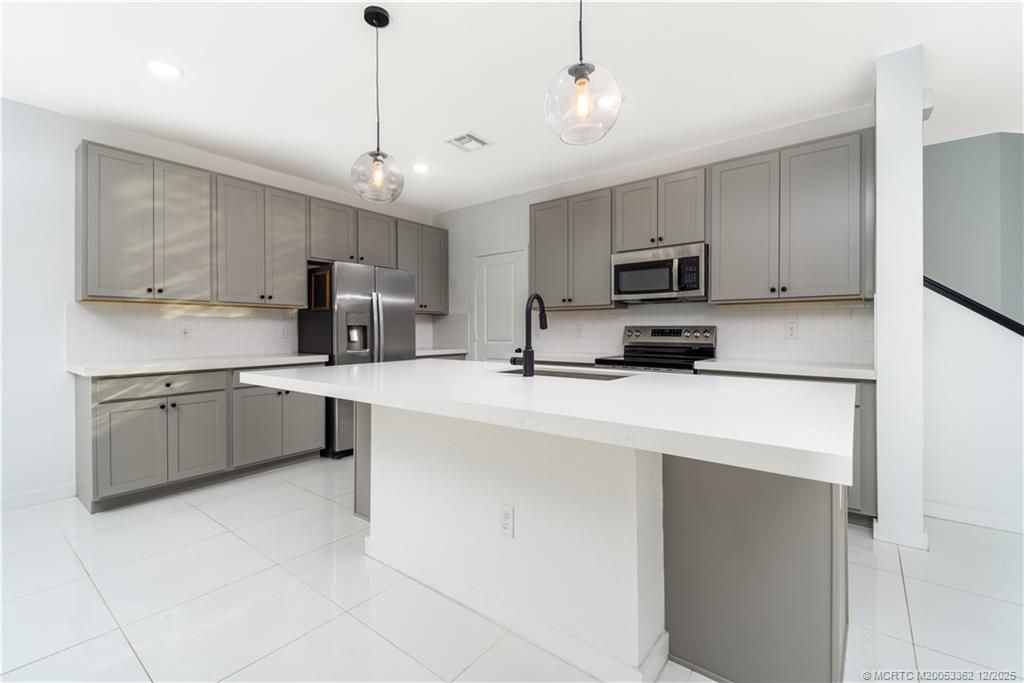 Photo of 668 NE Waters Edge Lane, Port Saint Lucie, FL 34983 (MLS # M20053362)