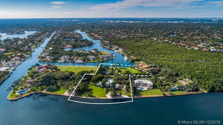 A once in a lifetime opportunity to purchase the largest parcel of land situated within the secure gates of Gables Estates.  The properties consist of 4.5 acres with 630 feet of combined water frontage over 2 lots.  The main residence is a 3.3 acre property with 450&#x2019; of direct bay frontage.  Enjoy expansive views of the bay out to Key Biscayne, South Beach and the Downtown Miami Skyline. Directly across the private street, sits an additional 1 acre waterfront lot, with 180&#x2019; of seawall - the perfect set up for yachters. This lot includes a tennis court, 2 boat lifts, and plenty of storage for water toys.  An additional 1.25  acre abutting waterfront vacant lot can be purchased with the sale for over 5.5 total acres &#x2014; making this the largest privately owned property in all of Gables Estates.