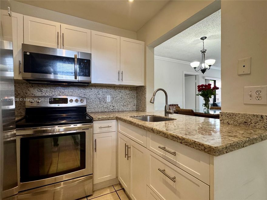 Modern 2/2 condo, 750 SqFt, with a private balcony and 1 dedicated parking space. This condo features an in-unit washer & dryer, plus a updated kitchen with sleek stainless steel appliances, stylish white cabinetry, and elegant marble countertops in both kitchen & bathrooms. Enjoy 14 miles of scenic walkways & bikeways winding around tranquil lakes, ideal for walks or bike rides. This second-floor unit (no elevator) offers a cozy, low-maintenance lifestyle. The Hammock Association fee is $260 quarterly, and Heron at the Hammocks is $260 monthly.