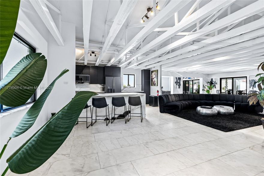 Rarely available home in Miami River's historic Spring Garden community. The home features an open layout, perfect for entertainment. With its 15-foot ceilings and exposed beams, the chef's kitchen creates a modern industrial vibe, while honed marble floors add elegance to the seamless layout. Enjoy alfresco dining on the covered terrace overlooking the sparkling pool. Additional highlights include a gym and a private guesthouse with its own bedroom, bathroom, kitchen, and entrance. Perfect for daily living and stylish entertaining, indoors or outdoors, this home is ideally situated on the Miami River in the charming Spring Garden neighborhood.