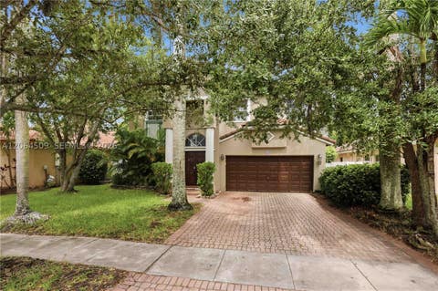 Photo of 1040 NW 185th Ave, Pembroke Pines, FL 33029 (MLS # A12064509)