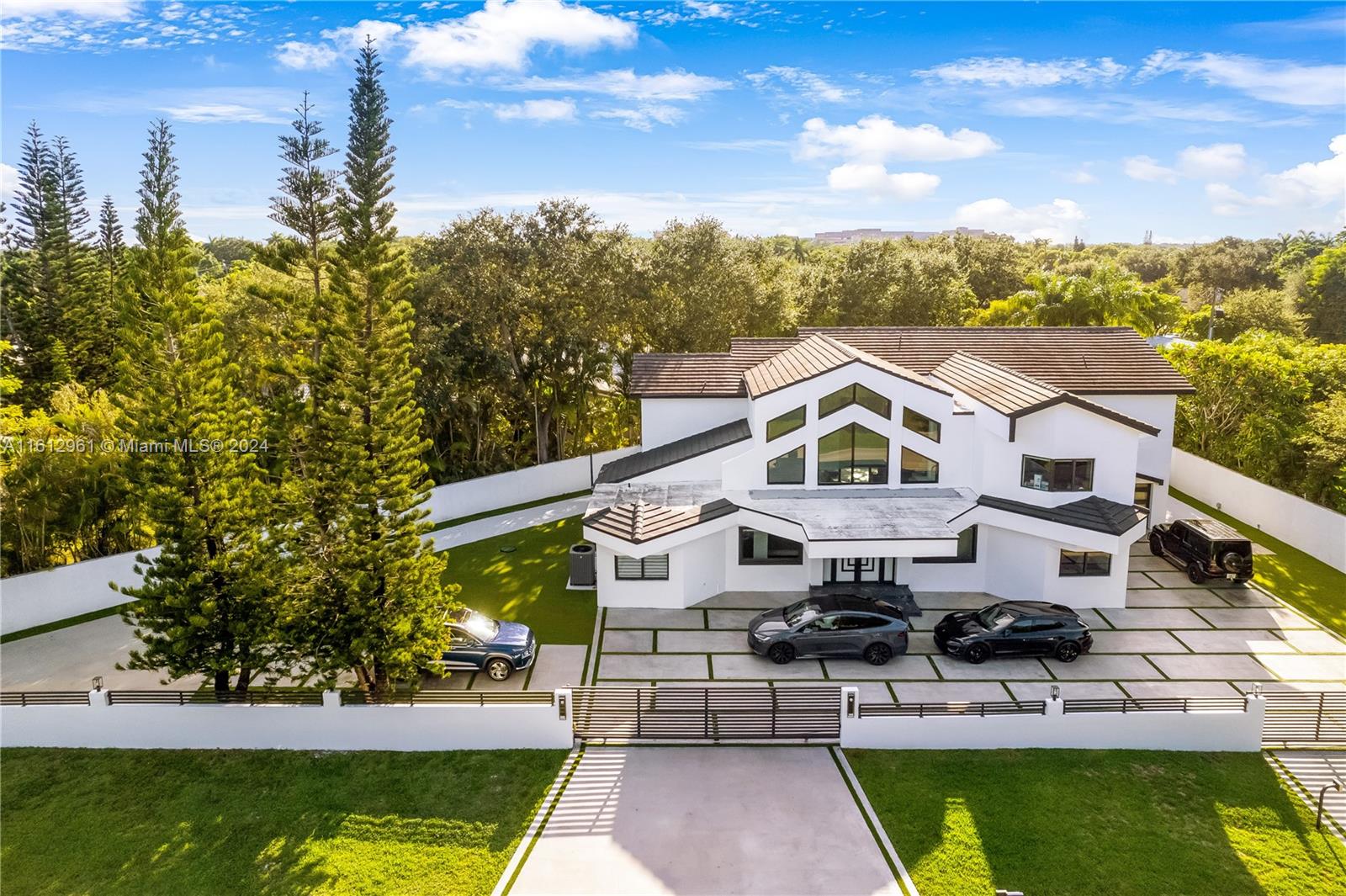 Discover unparalleled luxury and sophistication in this exquisitely remodeled estate, where no expense has been spared. This 5-bedroom, 5-bathroom masterpiece radiates elegance at every turn. Indulge in unique features such as a brand-new designer pool and jacuzzi, and an acrylic high-end garage door and fence. Imported rectified flooring and a stunning glass staircase with a balcony elevate this home to the epitome of opulence.
The open floor plan, illuminated by natural light, showcases a spacious kitchen equipped with the latest Miele appliances, while the entire property is seamlessly integrated with smart technology, including advanced lighting and a secure door lock system. This distinguished corner lot also boasts two 80-gallon water heaters, new A/C units, and a new tile roof.