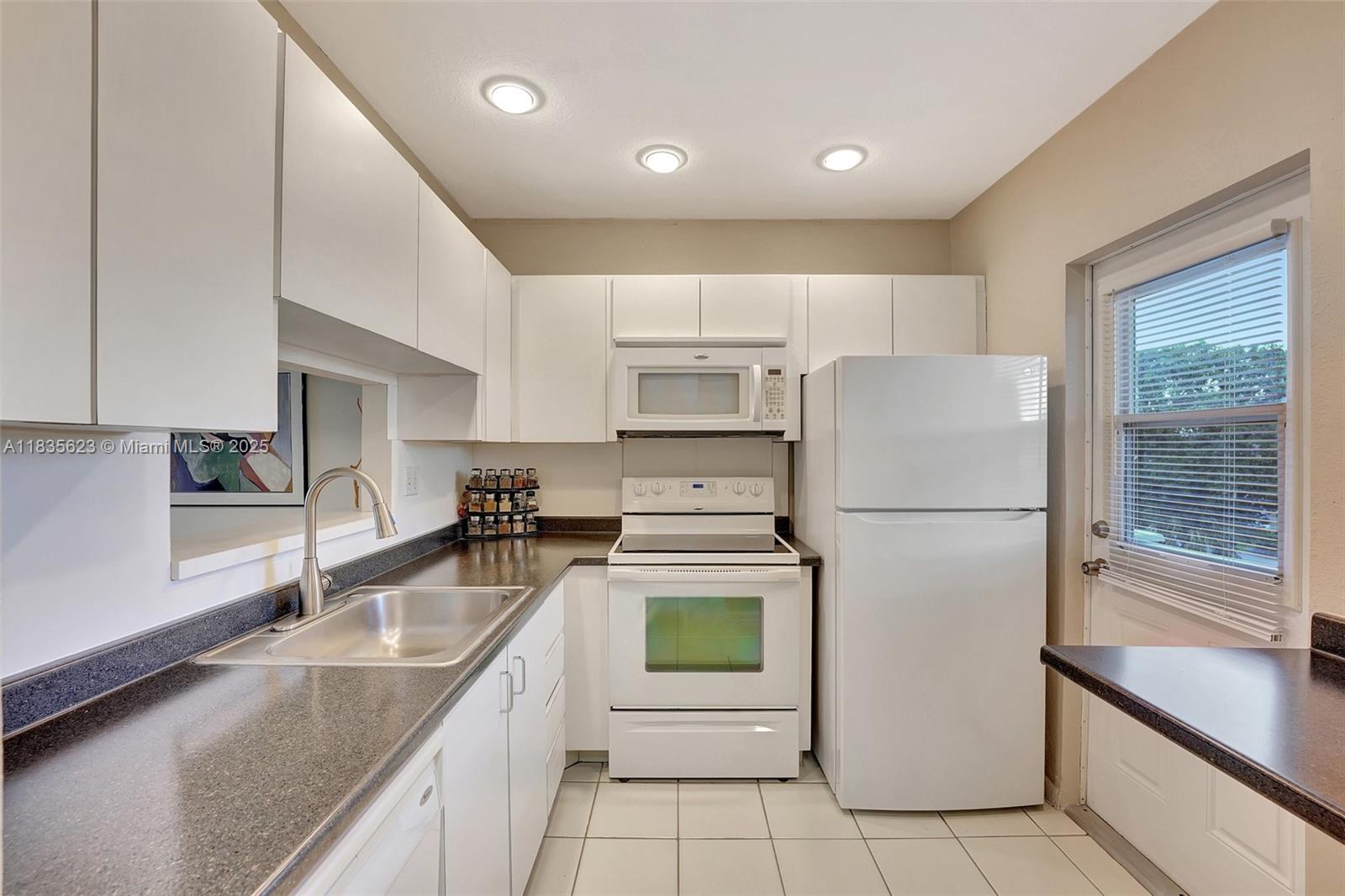 Wow! This is a steal! Gorgeous light and bright 2 bedroom 2 bathroom condo in Hawaiian Gardens Phase 6 in the LOTUS building for the price of a 1 bedroom! The unit features tile floor throughout, white kitchen cabinets & a florida room with lake views. .Directly on the top floor with nobody on top of you, this one will sell all furnished and turnkey. Amenities include a clubhouse with a library, gym, billiard room and kitchen, heated pool, BBQ, Shuffleboard and Petanque. This is a Hopa Verified community with tons of activities. Great opportunity, don't miss it!